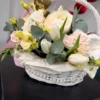 A delicate flower basket in milky cream tones