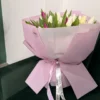 A bouquet of tulips in branded packaging by AIGUL Flowers
